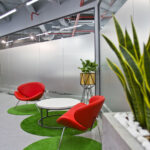 office sitting area lined by plants